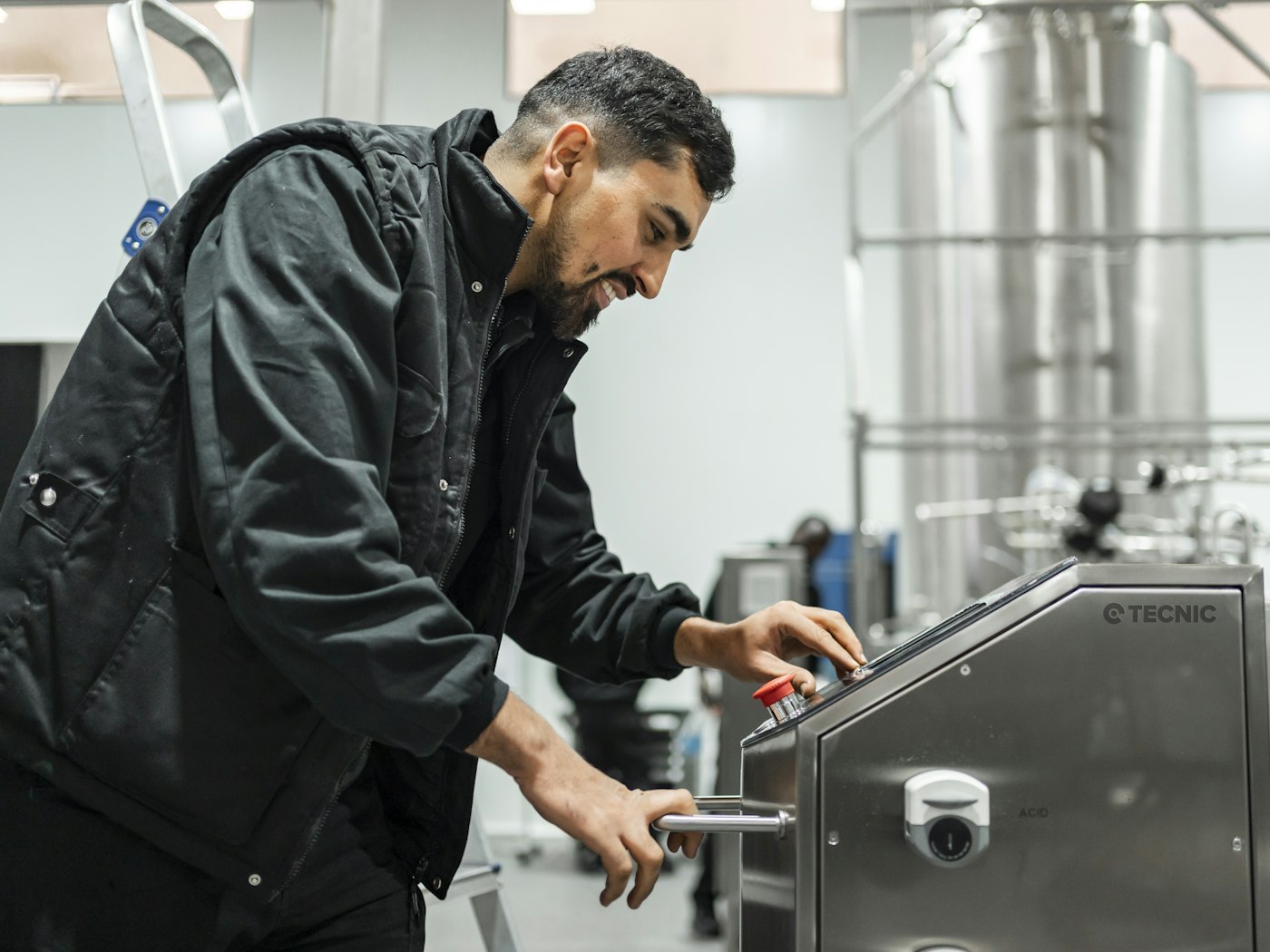 Engineer operating machinery on a factory floor