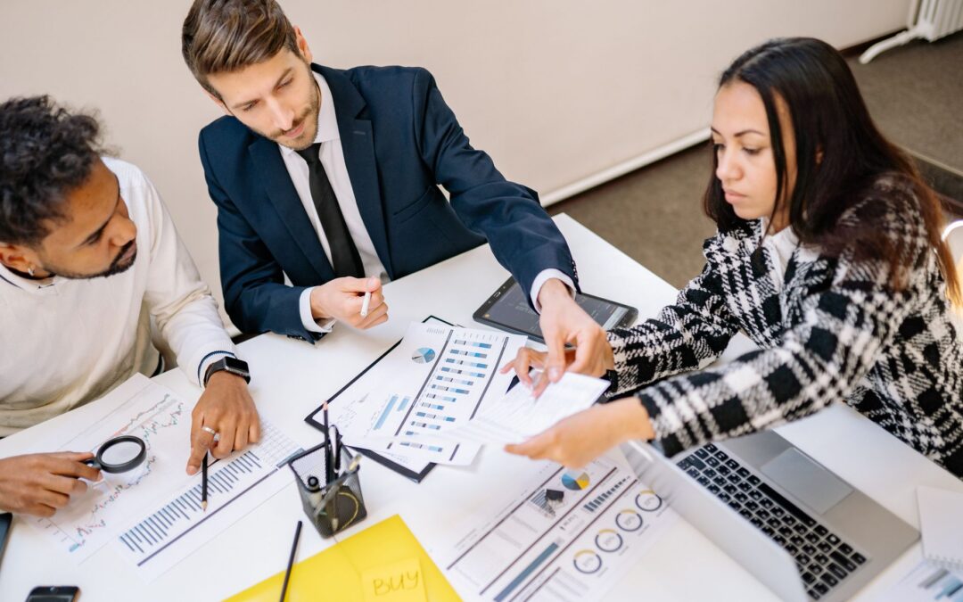 Business professionals engaging in a collaborative meeting with charts and documents.